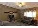 Cozy living room featuring neutral tones, plush seating, and a ceiling fan for added comfort at 10843 Sw 91St Ter, Ocala, FL 34481
