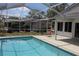 Screened-in pool, patio, and view of the backyard at 10843 Sw 91St Ter, Ocala, FL 34481