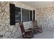 Inviting front porch with two rocking chairs, perfect for enjoying the outdoors and relaxing on summer evenings at 10843 Sw 91St Ter, Ocala, FL 34481