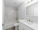 This bathroom has a shower over tub, nice tile work and a bright white vanity at 13349 Sw 113Th Pl, Dunnellon, FL 34432