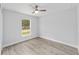 Clean and bright bedroom features neutral paint, ceiling fan and plank flooring at 13349 Sw 113Th Pl, Dunnellon, FL 34432