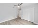 This is a simple bedroom with light gray walls, a ceiling fan and a closet at 13349 Sw 113Th Pl, Dunnellon, FL 34432