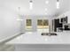 Bright open kitchen features quartz counters, stainless appliances, and sliding glass doors at 13349 Sw 113Th Pl, Dunnellon, FL 34432