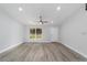 The living room features vinyl flooring, large windows for natural light, and a front door for convenient access at 13349 Sw 113Th Pl, Dunnellon, FL 34432