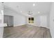 Open-concept space features wood-look vinyl flooring, bright white walls, and a kitchen with modern stainless steel appliances at 13349 Sw 113Th Pl, Dunnellon, FL 34432