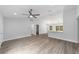 The open-concept living room featuring vaulted ceilings, vinyl flooring, a ceiling fan, and views to the backyard at 13349 Sw 113Th Pl, Dunnellon, FL 34432