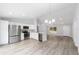 The living space features an open-concept kitchen with a stainless fridge, kitchen island and adjacent living and dining areas at 13349 Sw 113Th Pl, Dunnellon, FL 34432