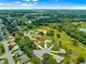 Beautiful aerial view of the home in a well-maintained 55+ community with golf course and lake at 13885 Del Webb Blvd, Summerfield, FL 34491