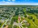 Expansive aerial view of the home with golf course and lush landscaping in a desirable 55+ community at 13885 Del Webb Blvd, Summerfield, FL 34491