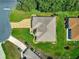 High definition overhead view of the home showing mature landscaping, manicured lawn, and hardscaped driveway at 13885 Del Webb Blvd, Summerfield, FL 34491