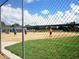 Chain link fenced baseball field with players on the diamond at 13885 Del Webb Blvd, Summerfield, FL 34491