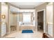 Bathroom with a tub, walk-in shower, and tile flooring at 13885 Del Webb Blvd, Summerfield, FL 34491