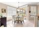 Dining area with round table, shutters, sliding glass doors and backyard views at 13885 Del Webb Blvd, Summerfield, FL 34491