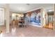 Dining room with large mural, traditional table and seating, and natural light from large windows at 13885 Del Webb Blvd, Summerfield, FL 34491