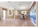 Dining area featuring tile flooring, a statement mural, and elegant furnishings with a chandelier, perfect for gatherings at 13885 Del Webb Blvd, Summerfield, FL 34491