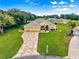Beautiful home featuring a 3-car garage, meticulously landscaped yard, and a patterned concrete driveway under a sunny sky at 13885 Del Webb Blvd, Summerfield, FL 34491