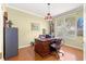 The home office features a wood desk, hardwood floors, overhead light, and natural light at 13885 Del Webb Blvd, Summerfield, FL 34491