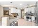 Bright kitchen with granite countertops, stainless steel appliances, and white cabinets at 13885 Del Webb Blvd, Summerfield, FL 34491