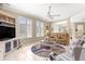 Inviting living room featuring tile floors, plantation shutters, and neutral decor, and comfortable seating at 13885 Del Webb Blvd, Summerfield, FL 34491