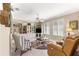 Cozy living room with built-in shelving, comfortable seating, and lots of natural light from plantation-shuttered windows at 13885 Del Webb Blvd, Summerfield, FL 34491