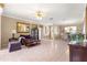 Spacious living room featuring neutral colored walls and tile flooring, alongside comfortable seating and elegant decor at 13885 Del Webb Blvd, Summerfield, FL 34491
