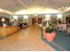 Spacious clubhouse lobby with tile flooring, plant accents, and chandeliers at 13885 Del Webb Blvd, Summerfield, FL 34491