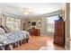 Spacious main bedroom featuring hardwood floors and natural light at 13885 Del Webb Blvd, Summerfield, FL 34491