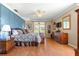 Large main bedroom showcasing hardwood floors and backyard access at 13885 Del Webb Blvd, Summerfield, FL 34491