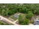 An aerial view reveals the home's private wooded surroundings and generous lot at 16231 Sw 20Th Ln, Ocala, FL 34481