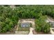 Aerial view of the home showcasing its nestled position within a lush, green forest at 16231 Sw 20Th Ln, Ocala, FL 34481
