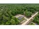 An aerial view of the home surrounded by many trees on a beautiful wooded lot at 16231 Sw 20Th Ln, Ocala, FL 34481