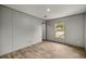 This is a bedroom featuring wood-look floors, a window, and neutral gray walls at 16231 Sw 20Th Ln, Ocala, FL 34481