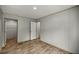 This bedroom includes wood-look floors, light gray walls and access to a closet at 16231 Sw 20Th Ln, Ocala, FL 34481