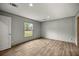 This bedroom features wood-look floors, a window, gray walls and base trim at 16231 Sw 20Th Ln, Ocala, FL 34481
