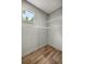 A walk-in closet with wood-look floors, a window and wire shelving for storage at 16231 Sw 20Th Ln, Ocala, FL 34481