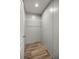 A small walk-in closet with wood-look floors and wire shelving at 16231 Sw 20Th Ln, Ocala, FL 34481
