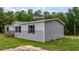 Side view of a house and the manicured lawn around it at 16231 Sw 20Th Ln, Ocala, FL 34481