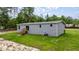 View of house with a back entry and steps and large grassy area at 16231 Sw 20Th Ln, Ocala, FL 34481