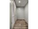 Hallway featuring closet space with louvered doors and neutral finishes at 16231 Sw 20Th Ln, Ocala, FL 34481
