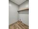 Dedicated laundry space with washer/dryer hookups and added shelving at 16231 Sw 20Th Ln, Ocala, FL 34481