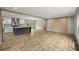 Bright, open-concept living space featuring modern flooring, island and a kitchen with stainless appliances at 16231 Sw 20Th Ln, Ocala, FL 34481