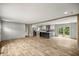 Bright, open-concept living space featuring modern flooring, island and a kitchen with stainless appliances at 16231 Sw 20Th Ln, Ocala, FL 34481