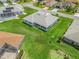 Aerial view of the home showcasing the manicured lawn, screened-in patio, and neighborhood at 17755 Se 117Th Cir, Summerfield, FL 34491