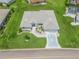 Aerial view highlighting the home's well-kept lawn, landscaping, and convenient driveway access at 17755 Se 117Th Cir, Summerfield, FL 34491