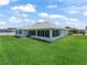 Spacious backyard with lush green grass, perfect for outdoor activities and relaxation at 17755 Se 117Th Cir, Summerfield, FL 34491
