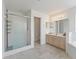 Bright bathroom features double sink vanity, step-in shower, and tile floors at 17755 Se 117Th Cir, Summerfield, FL 34491