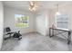 Bedroom offers tile floors, ceiling fan, natural light, and ample room for office or exercise equipment at 17755 Se 117Th Cir, Summerfield, FL 34491