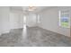 Bedroom with neutral walls, tile floors, ceiling fan, window with blinds, and access to bath and closet at 17755 Se 117Th Cir, Summerfield, FL 34491
