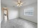 Spacious bedroom offers neutral colors, tile floors, ceiling fan, and natural light at 17755 Se 117Th Cir, Summerfield, FL 34491