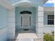 Inviting front entrance with arched doorway, white pillars, and tile flooring for a grand welcome at 17755 Se 117Th Cir, Summerfield, FL 34491